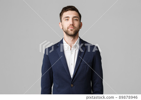 Business Concept - Young successful businessman posing over dark background. Isolated White Background. Copy space. 89878946