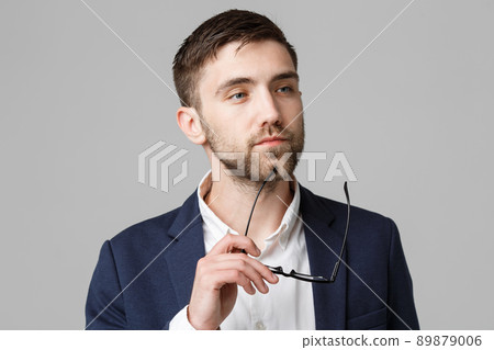 Business Concept - Portrait of a handsome businessman in suit with glasses serious thinking with stressful facial expression. Isolated White background. Copy Space. 89879006