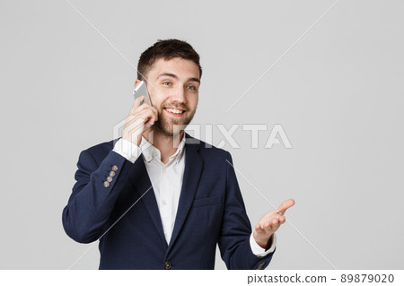 Lifestyle and Business Concept - Portrait of a handsome businessman enjoy talking with mobile phone. Isolated White background. Copy Space. 89879020