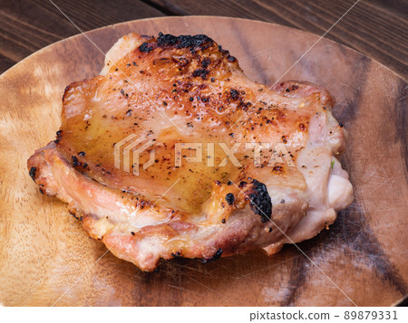 Grilled chicken with chicken thigh seasoned with salt and pepper. Grilled chicken with chicken thigh seasoned with salt and pepper. 89879331