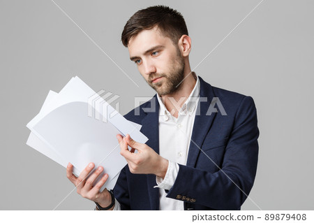 Business Concept - Portrait Handsome Business man serious working with annual report. White Background. Copy Space. 89879408