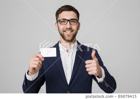 Business Concept - Portrait Handsome Business man showing name card with smiling confident face and thump up. White Background.Copy Space. Business Concept - Portrait Handsome Business man showing name card with smiling confident face and thump up. White Background.Copy Space. 89879415