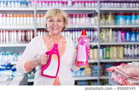 Positive female holding goods for washing Positive female holding goods for washing 89880345