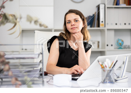 Female employee having productive day at work in office 89880347