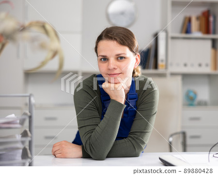 Young female cleaner working productively on task in office Young female cleaner working productively on task in office 89880428