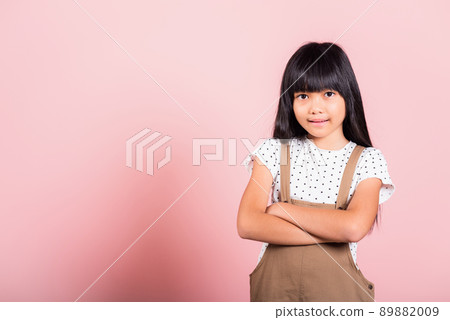 Asian little kid 10 years old smiling with arms crossed 89882009