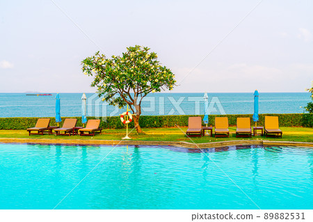chair pool around swimming pool with sea background 89882531