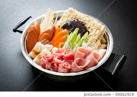 Budae Jjigae or Budaejjigae (Army stew or Army base stew). It is loaded with Kimchi, spam, sausages, ramen noodles and much more Budae Jjigae or Budaejjigae (Army stew or Army base stew). It is loaded with Kimchi, spam, sausages, ramen noodles and much more 89882929