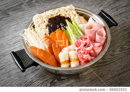 Budae Jjigae or Budaejjigae (Army stew or Army base stew). It is loaded with Kimchi, spam, sausages, ramen noodles and much more Budae Jjigae or Budaejjigae (Army stew or Army base stew). It is loaded with Kimchi, spam, sausages, ramen noodles and much more 89882932