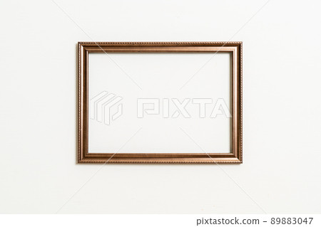 empty picture frame on white wall background 89883047