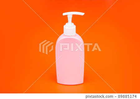 Cosmetic bottle isolated on orange Cosmetic bottle isolated on orange 89885174