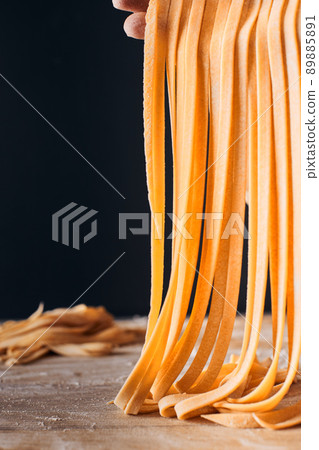 Making homemade pasta. The concept of healthy homemade food, Italian traditions. Vertical photo. 89885891