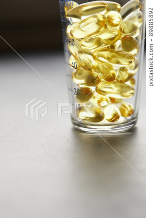 Capsules of omega-3 fatty acids on a gray background. The concept of medicine and a healthy lifestyle. Front view. 89885892