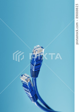 Two Ethernet Cable Connectors Patch cord cord close-up isolated on a blue background with free space 89888615