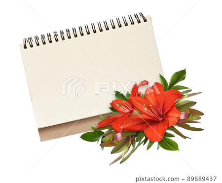 Red amaryllis flowers, leucadendron and ruscus in a floral arrangement in a corner of empty notepad isolated on white 89889437