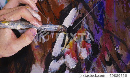 Artist designer draws an eagle on the wall. Craftsman decorator paints a picture with acrylic oil color brush. Close-up dark magic cinematic look. Artist designer draws an eagle on the wall. Craftsman decorator paints a picture with acrylic oil color brush. Close-up dark magic cinematic look. 89889536