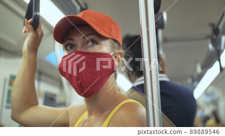 Woman travel caucasian ride at overground train airtrain with wearing protective medical mask. Girl tourist at airtrain with respirator. People mask. Woman travel caucasian ride at overground train airtrain with wearing protective medical mask. Girl tourist at airtrain with respirator. People mask. 89889546