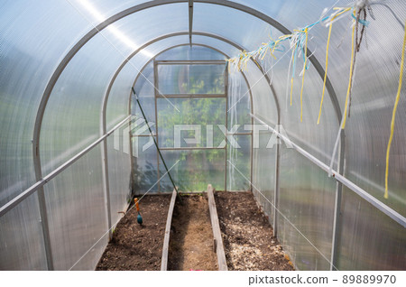 Empty small greenhouse in the countryside. Empty small greenhouse in the countryside. 89889970