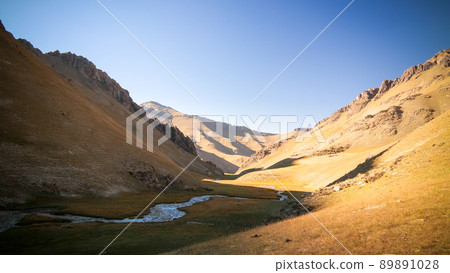 Sunset view to Tash-Rabat river and valley in Naryn province, Kyrgyzstan 89891028