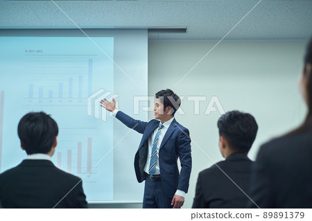 A man giving a presentation on a projector 89891379