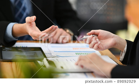 Two professional businesspeople checking, analyzing financial reports together at office 89892029