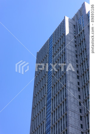 A group of skyscrapers in a sunny city during the fresh green season A group of skyscrapers in a sunny city during the fresh green season 89893186
