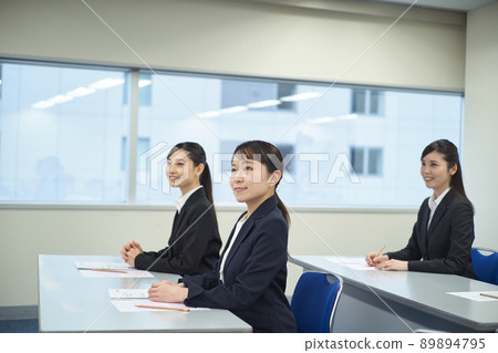 Women taking a written exam Women taking a written exam 89894795