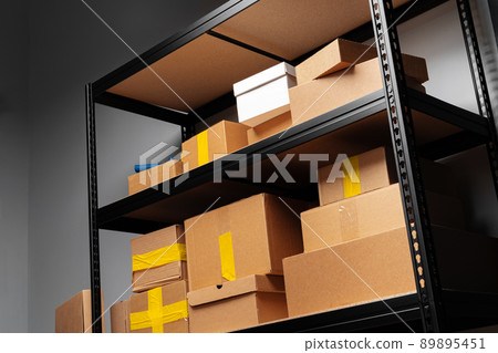 Rack shelves with paper boxes in warehouse. Rack shelves with paper boxes in warehouse. 89895451
