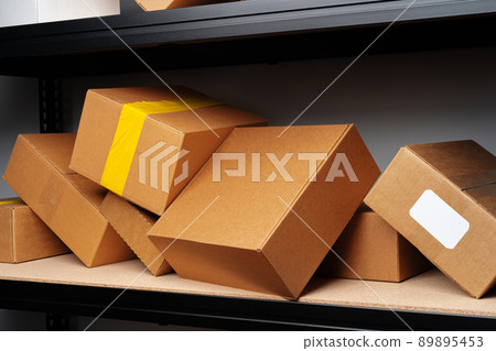 Rows of shelves with cardboard boxes in modern warehouse Rows of shelves with cardboard boxes in modern warehouse 89895453