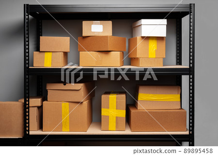 Rows of shelves with cardboard boxes in modern warehouse Rows of shelves with cardboard boxes in modern warehouse 89895458