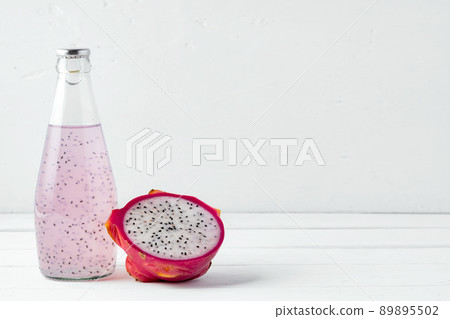 Glass bottle of dragon fruit drink on white background 89895502