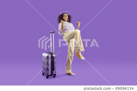 Happy cheerful girl with purple travel bag excited about going on summer vacation 89896154