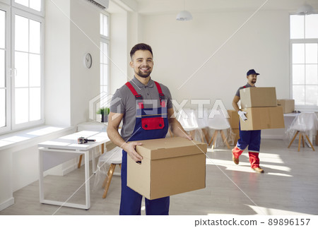 Smiling movers load packages working for delivery company Smiling movers load packages working for delivery company 89896157
