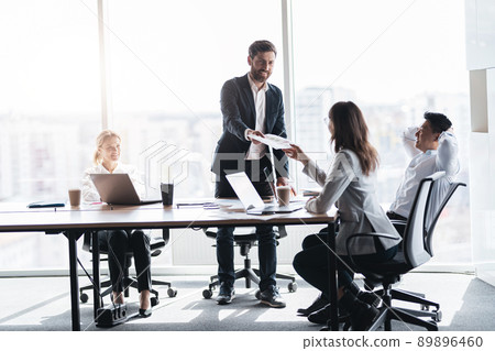 Corporate business team and manager in a meeting room at modern office with panoramic windows Corporate business team and manager in a meeting room at modern office with panoramic windows 89896460