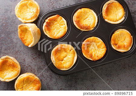 Traditional Portuguese cheesecakes called Queijadas de Sintra close-up in a baking dish. Horizontal top view 89896715