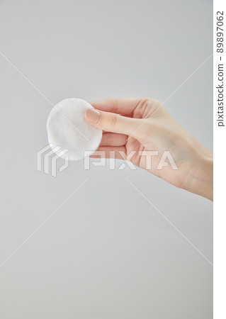 Front view of hand using cotton pad on white background  89897062