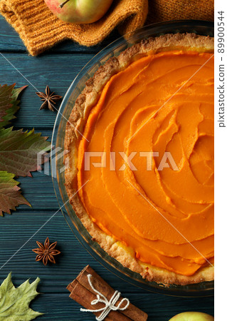 Concept of tasty food with pumpkin pie on wooden background Concept of tasty food with pumpkin pie on wooden background 89900544