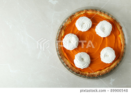 Pumpkin pie in round dish on gray background Pumpkin pie in round dish on gray background 89900548