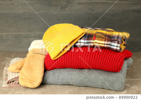 Concept of winter clothes on gray textured table Concept of winter clothes on gray textured table 89900922