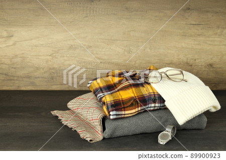 Concept of winter clothes on dark wooden table Concept of winter clothes on dark wooden table 89900923