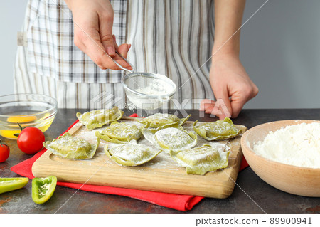 Concept of cooking ravioli on dark table Concept of cooking ravioli on dark table 89900941
