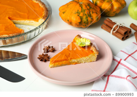 Concept of tasty food with pumpkin pie on white background 89900993