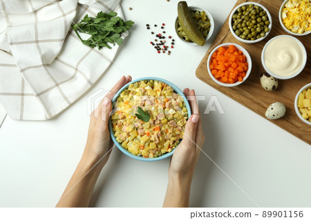 Concept of cooking Olivier salad on white background Concept of cooking Olivier salad on white background 89901156