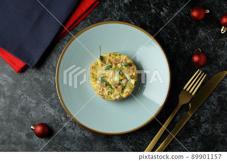 Christmas concept of tasty food with Olivier salad on black smokey background Christmas concept of tasty food with Olivier salad on black smokey background 89901157