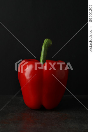 Red bell pepper on dark table, close up Red bell pepper on dark table, close up 89901202