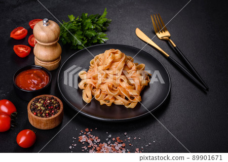 Tasty appetizing pasta tagliatelle spaghetti with tomato sauce and parmesan Tasty appetizing pasta tagliatelle spaghetti with tomato sauce and parmesan 89901671