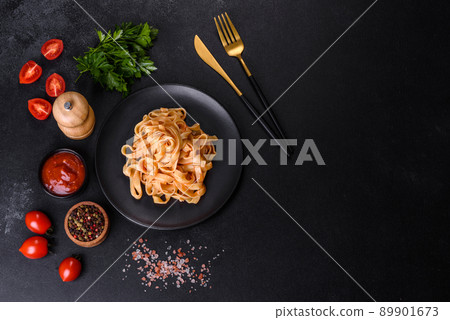 Tasty appetizing pasta tagliatelle spaghetti with tomato sauce and parmesan Tasty appetizing pasta tagliatelle spaghetti with tomato sauce and parmesan 89901673