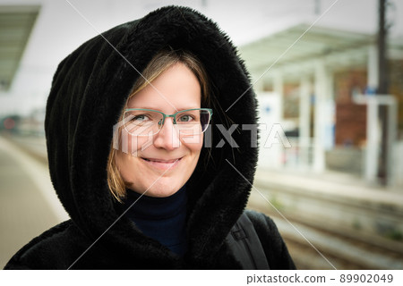 Attractive thirty year old white woman posing in a black furry coat 89902049