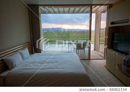 A room made of wood and a rice field seen from there 89902154