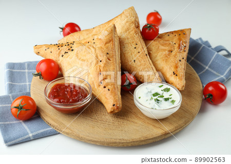 Concept of tasty food with samsa on white background Concept of tasty food with samsa on white background 89902563